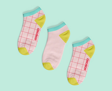Three Patterned Socks on a Green Background