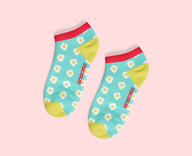 Two Patterned Socks on a Pink Background