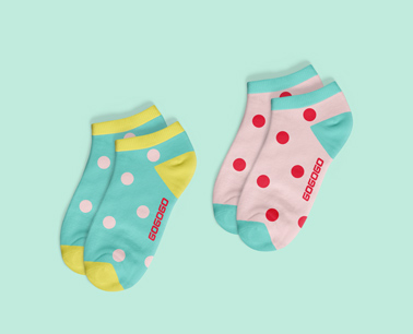 Two Pairs of Socks on a Green Background