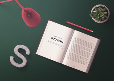 Open Book and a Pencil on a Writing Desk