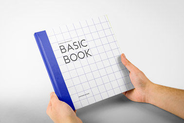 Hand, die ein quadratisches Hardcover-Buch hält