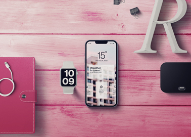 Um iPhone com um Apple Watch e Artigos de Papelaria