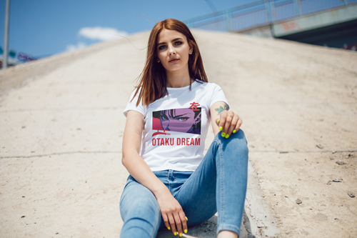 Женщина в футболке сидит на земле