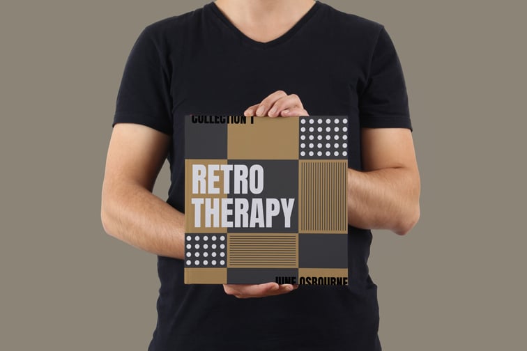 正方形の本を保持している男