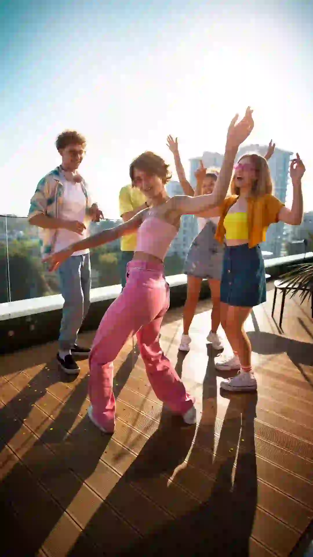 Friends dancing on a rooftop