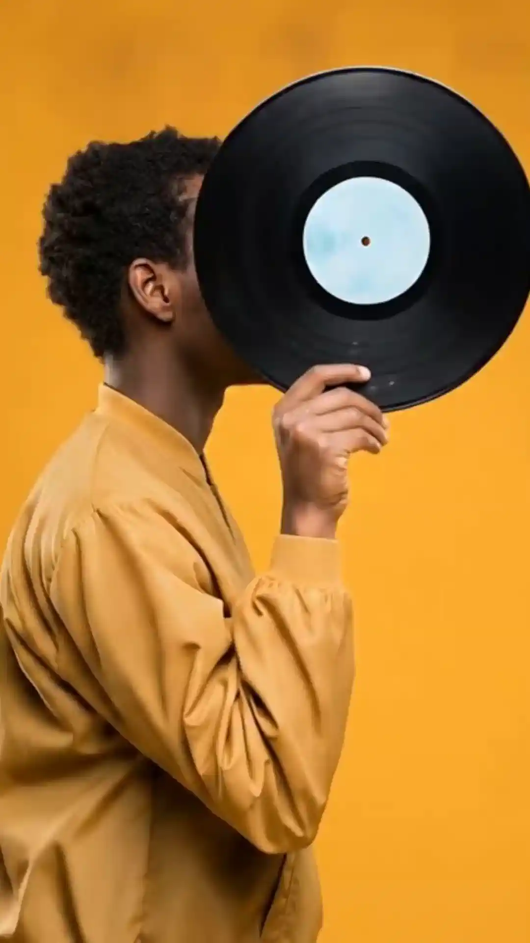 Vinyl record held to a face