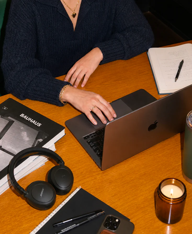 Hands typing on laptop